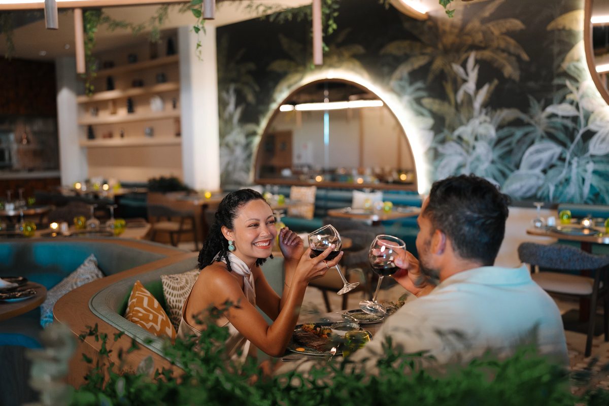A couple shares wine and conversation at an intimate restaurant table